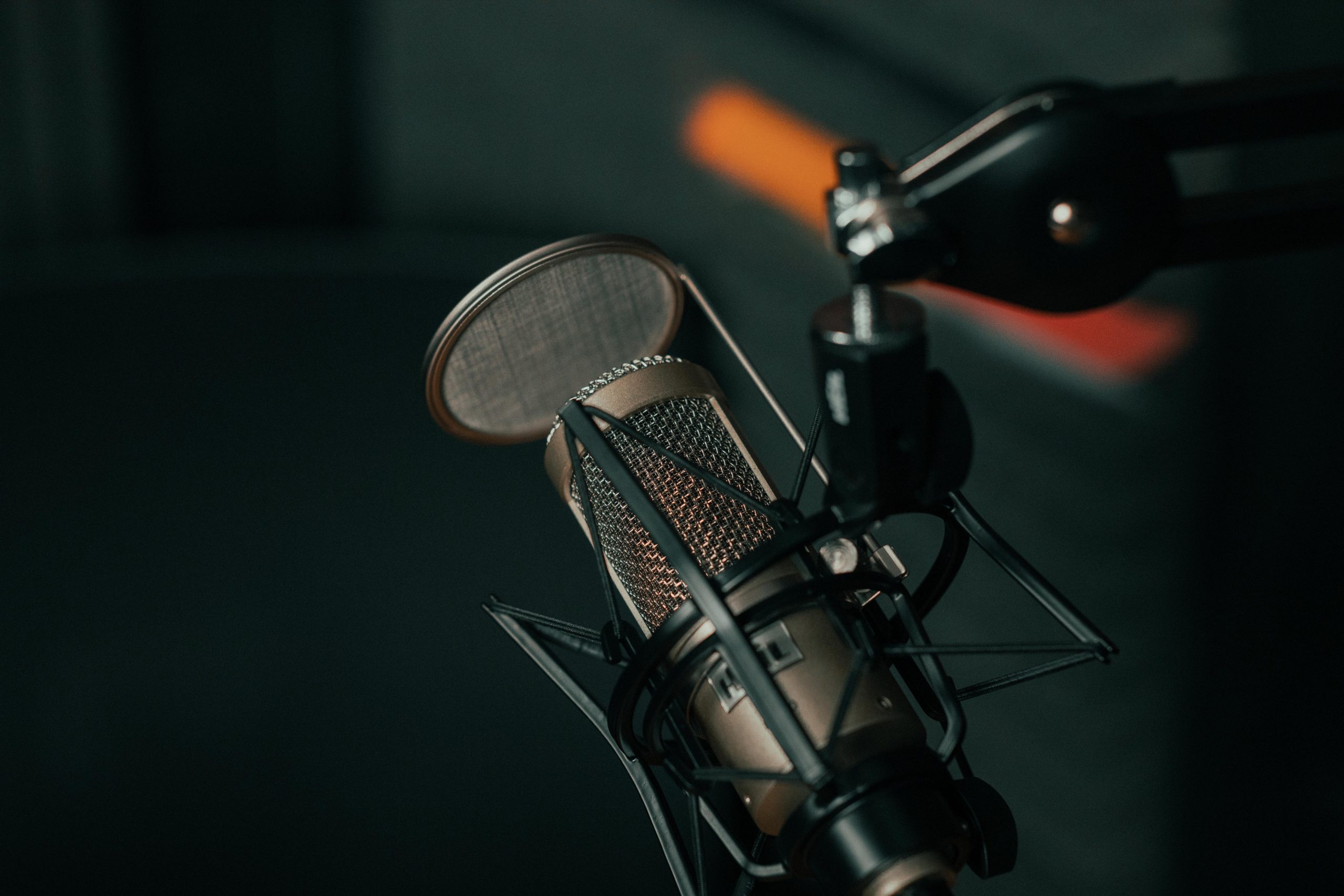 Close up shot of a microphone being used during a podcast recording for article on basic guide to product videos.